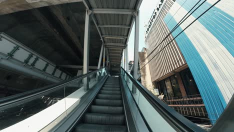 Tourist-ascending-an-escalator-in-the-center-of-Bangkok