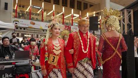 Indonesian-Couple-wearing-traditional-ethnic-costume-walks-onto-stage-during-fashion-show