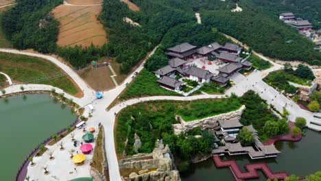Cinematic-aerial-view-of-fun-water-park-area-at-Huaxiacheng-theme-park,-China