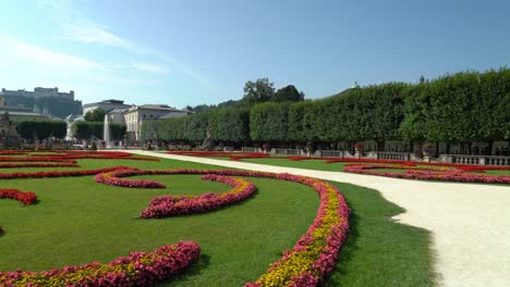 Panoramic-View-of-Beautiful-Gardens-of-Mirabell-Palace-with-Fountain-in-the-Middle-and-Fortress-Hohensalzburg-in-Background