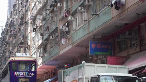 Double-decker-tram-riding-on-Chun-Yeung-Street-with-public-housing-residential-building-in-the-background