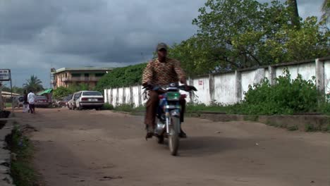 Motorcycle-taxis--on-an-unpaved-road-in-Nigeria