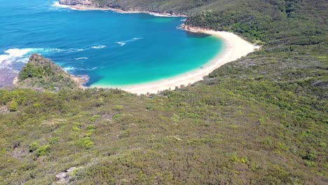 Drone-aerial-landscape-bushland-view-of-ocean-beach-trees-Maitland-Bay-Bouddi-National-Park-Central-Coast-NSW-travel-tourism-holiday-spot-Australia-4K