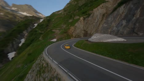 Yellow-Porsche-911-on-the-road-of-a-mountain-passage