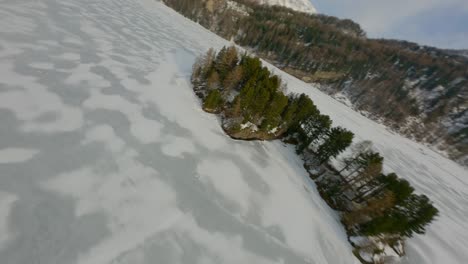 Flight-across-a-frozen-lake-between-high-mountains