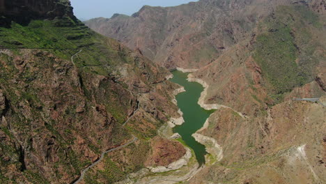 Aerial-view-traveling-in-over-the-Parralillo-dam-on-a-sunny-day-on-the-island-of-Gran-Canaria