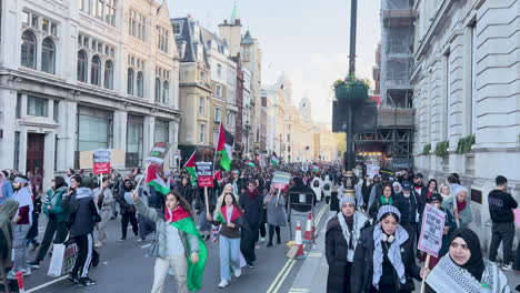 Pro-Palestinian-march-draws-thousands-in-London---huge-number-of-marchers-holding-flags,-banners---Big-Ben-tower-in-the-background