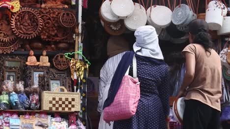 Visitors-shop-at-a-souvenir-shop-in-Tabanan,-Bali,-Indonesia