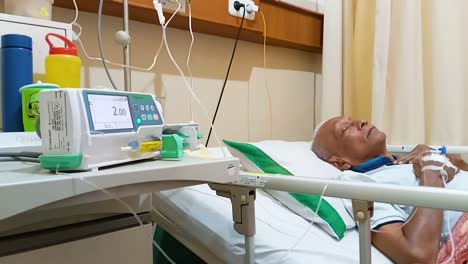 Male-patient-on-bed-in-hospital,-Morphine-hospital-with-electronic-control-and-patients-sleeping
