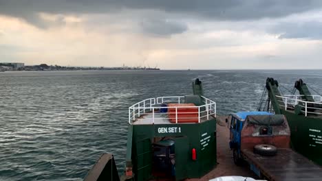 A-time-lapse-video-documenting-the-journey-of-a-cargo-ship-transporting-vehicles-across-the-sea,-traveling-from-Samal-Island-to-Davao-City