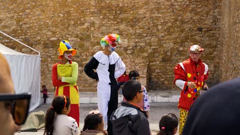 a-clown-does-his-show-in-front-of-children-in-the-medina-in-hammamet-tunisia