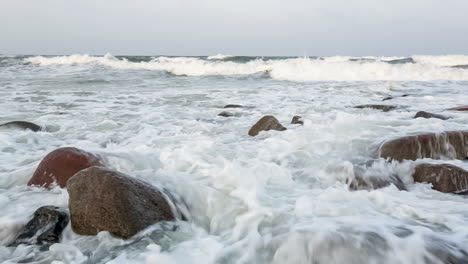 Waves-and-foam-on-rocky-beach