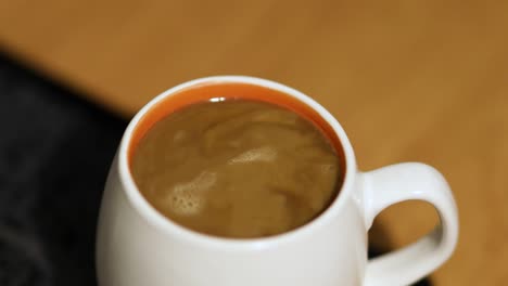 Pouring-milk-into-coffee-cup