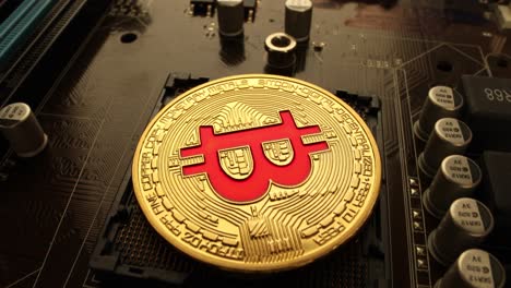 Gold-Bit-Coin-BTC-coins-on-the-motherboard.-Bitcoin-is-a-worldwide-cryptocurrency-and-digital-payment-system-called-the-first-decentralized-digital-currency.