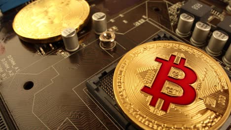 Gold-Bit-Coin-BTC-coins-on-the-motherboard.-Bitcoin-is-a-worldwide-cryptocurrency-and-digital-payment-system-called-the-first-decentralized-digital-currency.