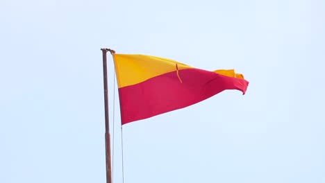 Flag-of-Jaisalmer-in-slow-motion-against-the-sky,-Rajasthan,-India