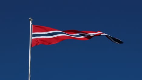 Norway-pennant-flag-waving-in-the-wind-against-deep-blue-sky.