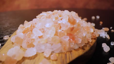 Himalayan-pink-salt-in-a-wooden-is-used-to-flavor-food.-Due-mainly-to-marketing-costs,-pink-Himalayan-salt-is-up-to-twenty-times-more-expensive-than-table-or-sea-salt.-Loop-video.