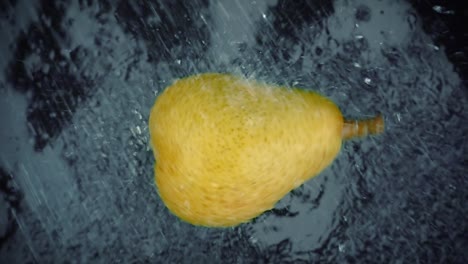 Pear-with-clear-water-splash-on-black-background.-Super-Slow-Motion-Loop.