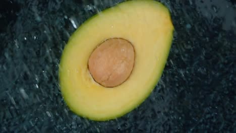 Avocado-with-clear-water-splash-on-black-background.-Super-Slow-Motion-Loop.