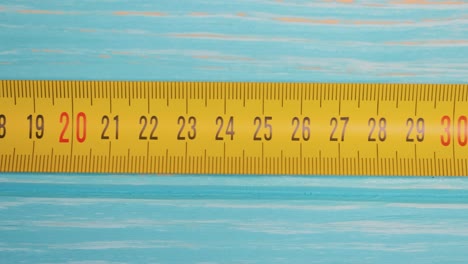 Roll-of-measuring-tape-in-motion-macro