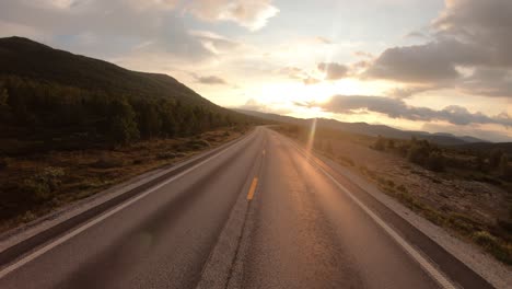 Driving-a-Car-on-a-Road-in-Norway-at-dawn