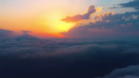 Flying-over-the-clouds-with-the-late-sun.-Sunrise-or-sunset-colorful-sky-background.