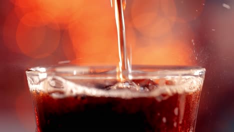 Cola-with-splashing-bubbles-slow-motion-on-a-blurry-light-,blurry-background.