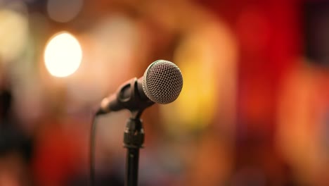Microphone-on-stage-against-a-background-of-auditorium.