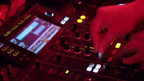 Nightclub,-nightlife-concept.-DJ-hands-mixing-DJ-remote.
