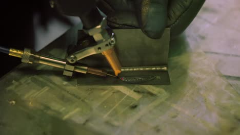 Laser-welding-machine-with-hand-hold-gun.-Laser-welding-is-shown-in-close-up.