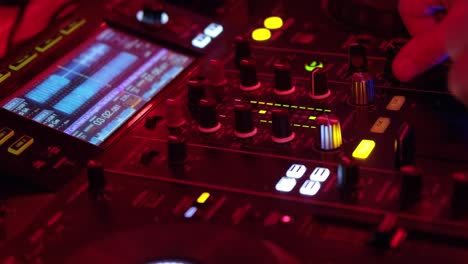 Nightclub,-nightlife-concept.-DJ-hands-mixing-DJ-remote.