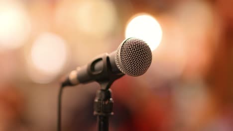 Microphone-on-stage-against-a-background-of-auditorium.