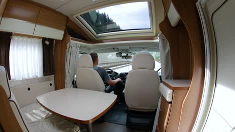 Man-driving-on-a-road-in-the-Camper-Van