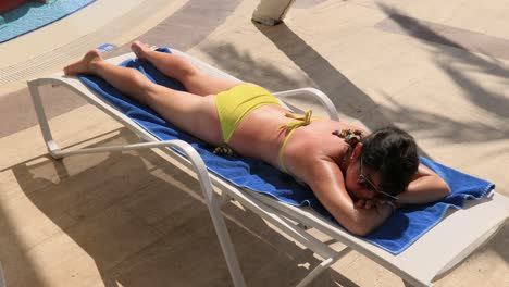 Woman-is-sunbathing-on-a-sun-lounger-while-on-vacation.