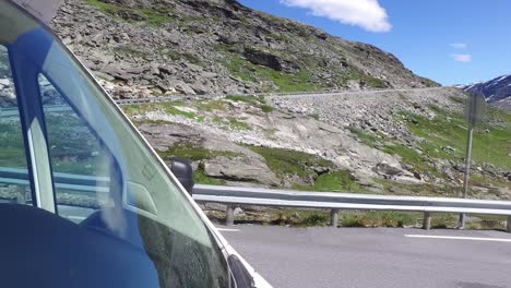Couple-goes-on-a-mountain-road-in-Norway-by-Camper-Van-RV.
