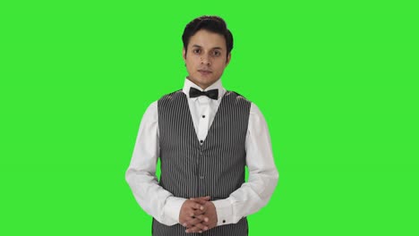Happy-Indian-waiter-looking-to-the-camera-Green-screen