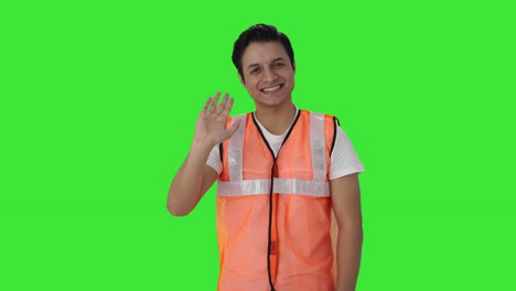 Happy-Indian-airport-ground-staff-waving-Hi-Green-screen