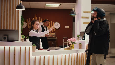 Hotel-staff-greeting-tourist-in-lobby