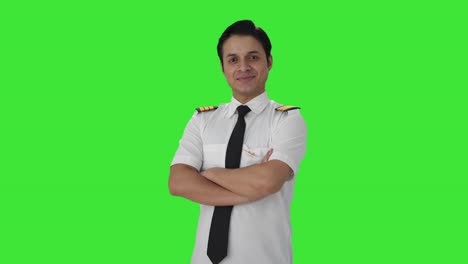 Portrait-of-Happy-Indian-pilot-standing-crossed-hands-Green-screen