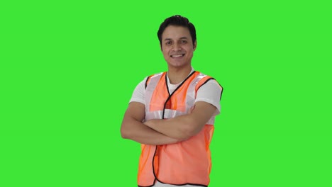 Portrait-of-Happy-Indian-airport-worker-standing-crossed-hands-Green-screen