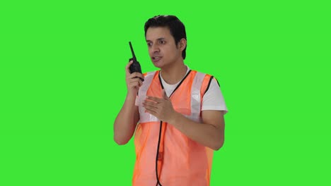 Angry-Indian-airport-ground-staff-worker-shouting-on-walkie-talkie-Green-screen