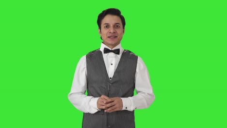 Happy-Indian-waiter-talking-to-the-camera-Green-screen