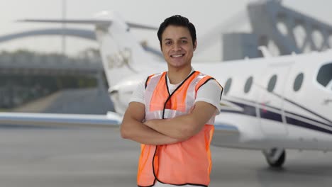 Portrait-of-Happy-Indian-airport-ground-staff-worker-standing-crossed-hands