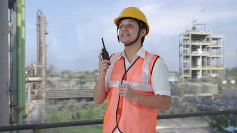Happy-Indian-architect-giving-directions-on-walkie-talkie