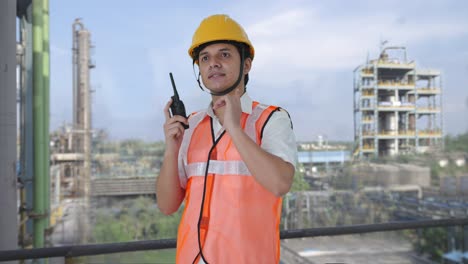 Happy-Indian-architect-giving-instructions-on-walkie-talkie