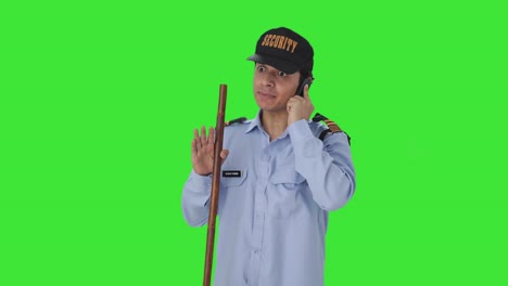 Angry-Indian-security-guard-shouting-on-someone-on-call-Green-screen