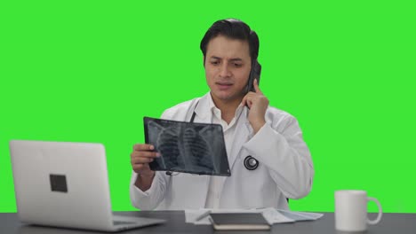 Sad-Indian-doctor-explaining-X-ray-report-on-phone-Green-screen