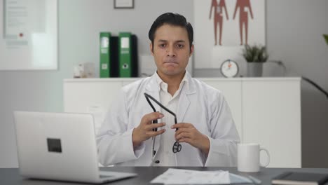 Sad-Indian-doctor-removing-stethoscope-from-shoulders
