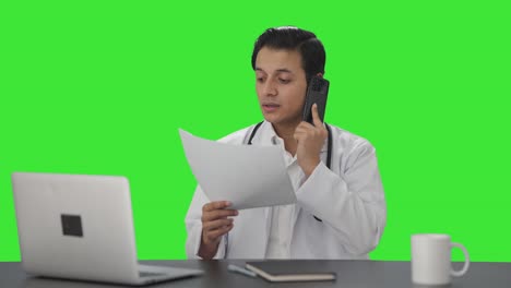 Sad-Indian-doctor-delivering-bad-news-on-phone-Green-screen